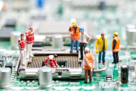 depositphotos_42979305-stock-photo-team-of-engineers-repairing-circuit